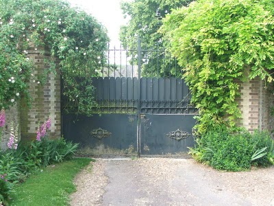how-we-came-to-live-here-my-french-country-home large metal gate with bushes on either side