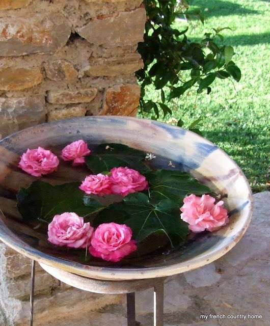 summertime-living-easy-2-my-french-country-home stone basin with roses and leaves floating in water