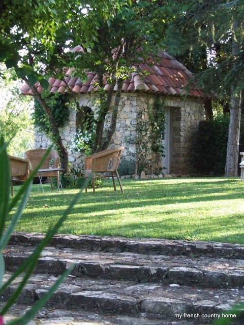 wicker chairs in front of the stone garden shed