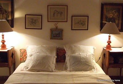 summertime-living-easy-2-my-french-country-home bed with white linens and paintings at the head