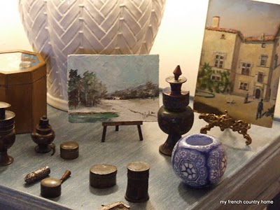 summertime-living-easy-2-my-french-country-home knickknacks on a side table with small paintings