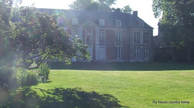 large red brick chateau with lawn