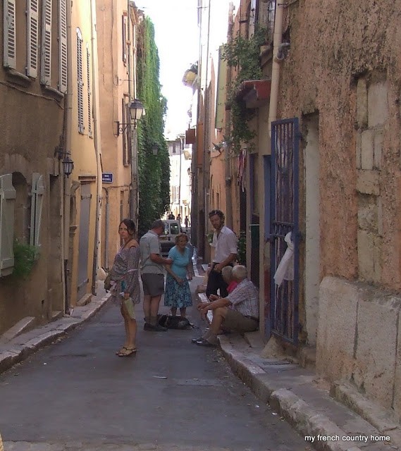 people chatting in a narrow street