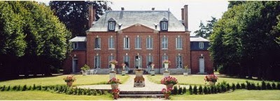 large brick chateau with front gardens