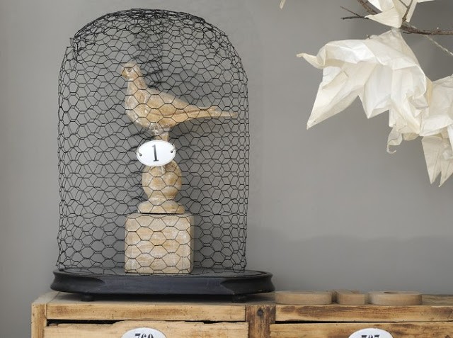 wooden bird in chicken wire dome display
