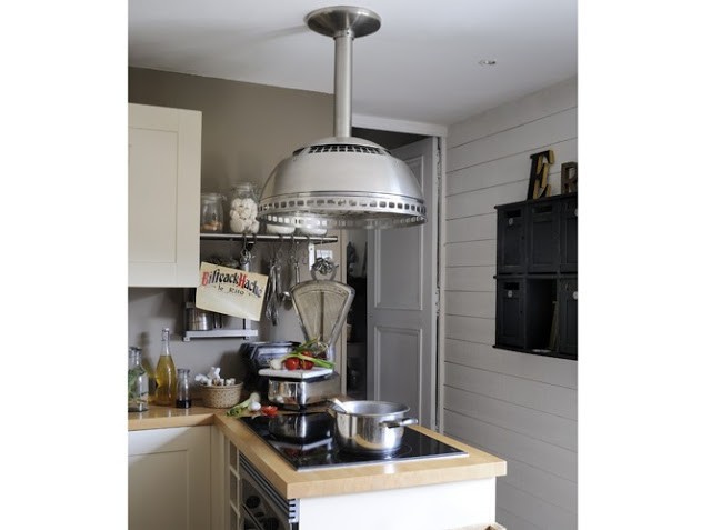 industrial lamp over a cooktop in the kitchen