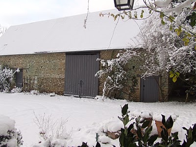 large barn covered in snow