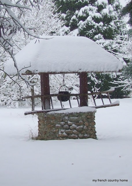 snow-covered stone well