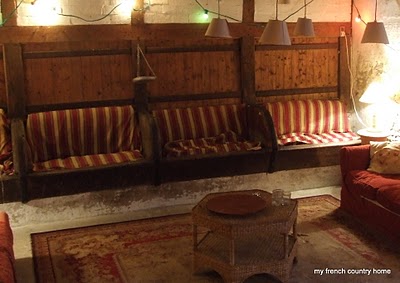 mangers turned into barn seating, with lights strung up