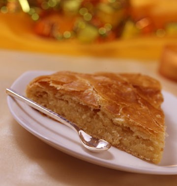 a slice of almond tarte with a tiny spoon
