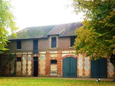stable building with intricate brickwork and large doors