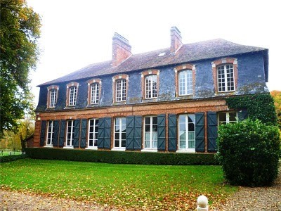 large outbuilding with slate roof and shutters