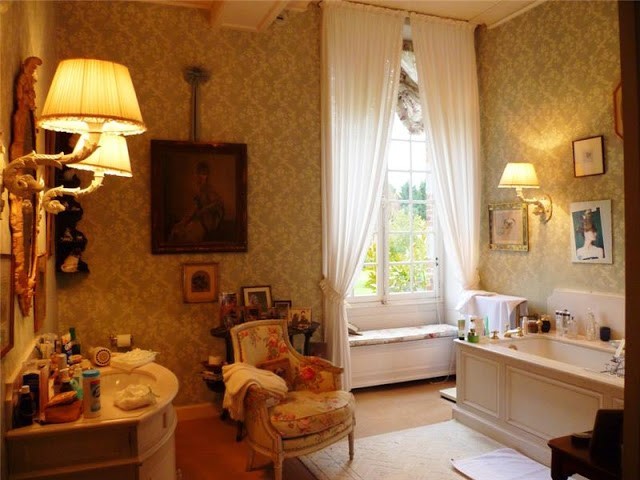 large bathroom with high ceiling, window seat, dressing area, and bathtub