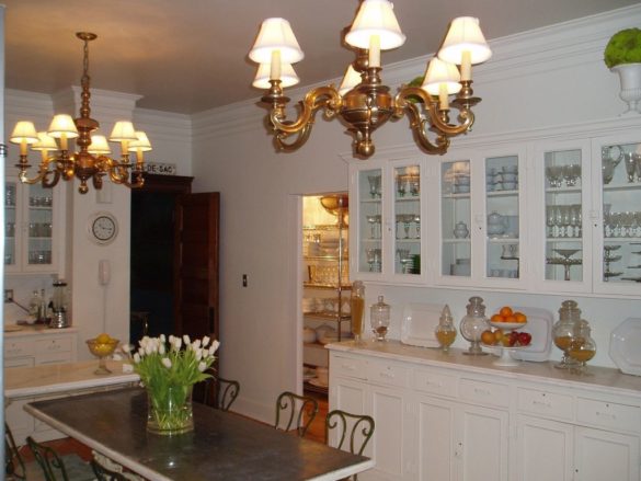real-french-kitchens-home-pics-my-french-country-home white kitchen with chandeliers and central table
