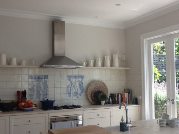 real-french-kitchens-home-pics-my-french-country-home white kitchen with ceramic backspash and stainless steel hood over stove