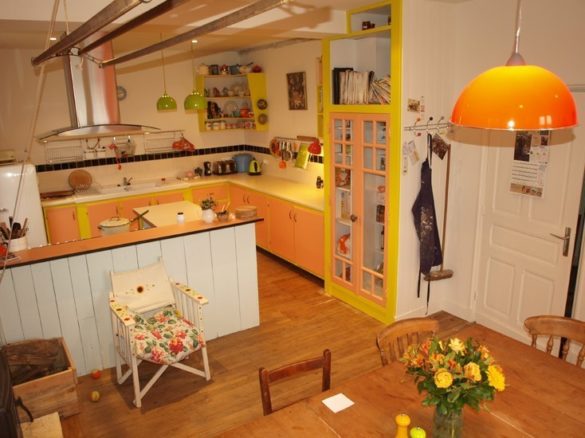 real-french-kitchens-home-pics-my-french-country-home bright orange and yellow kitchen with white cabinets and wooden farm table