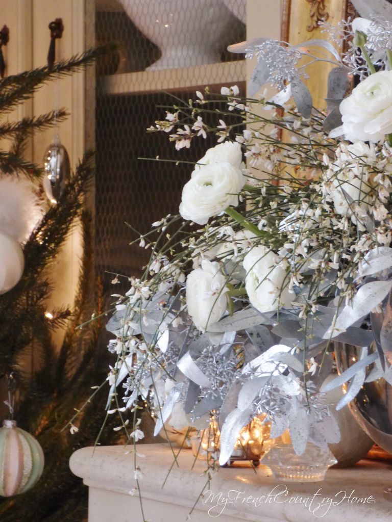 silver and white christmas decoration on french country fireplace