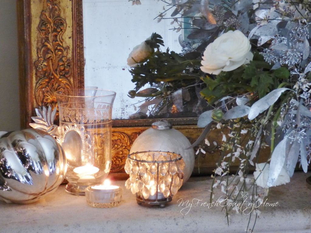silver and white christmas decoration on french country fireplace