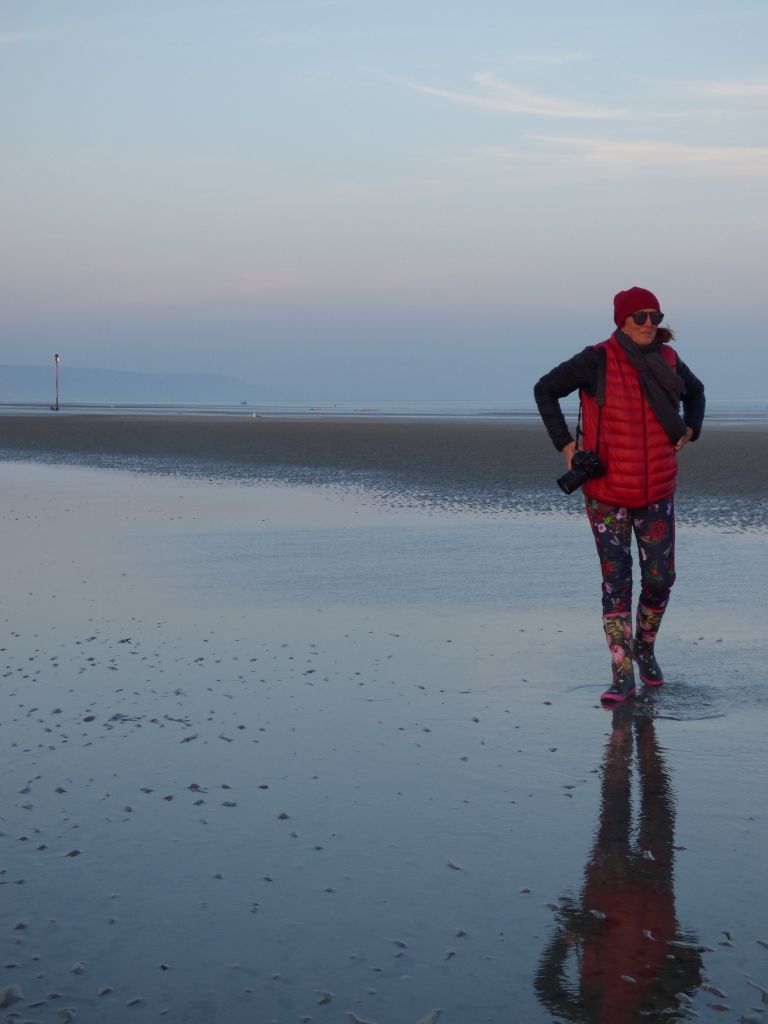woman on beach with camera