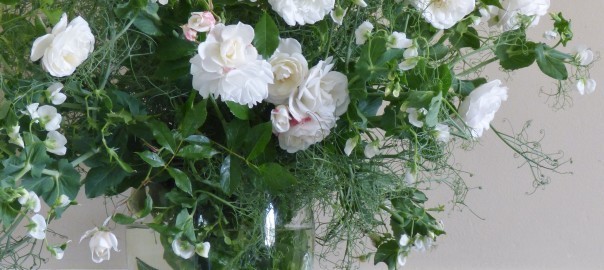 white roses and peas in a vase