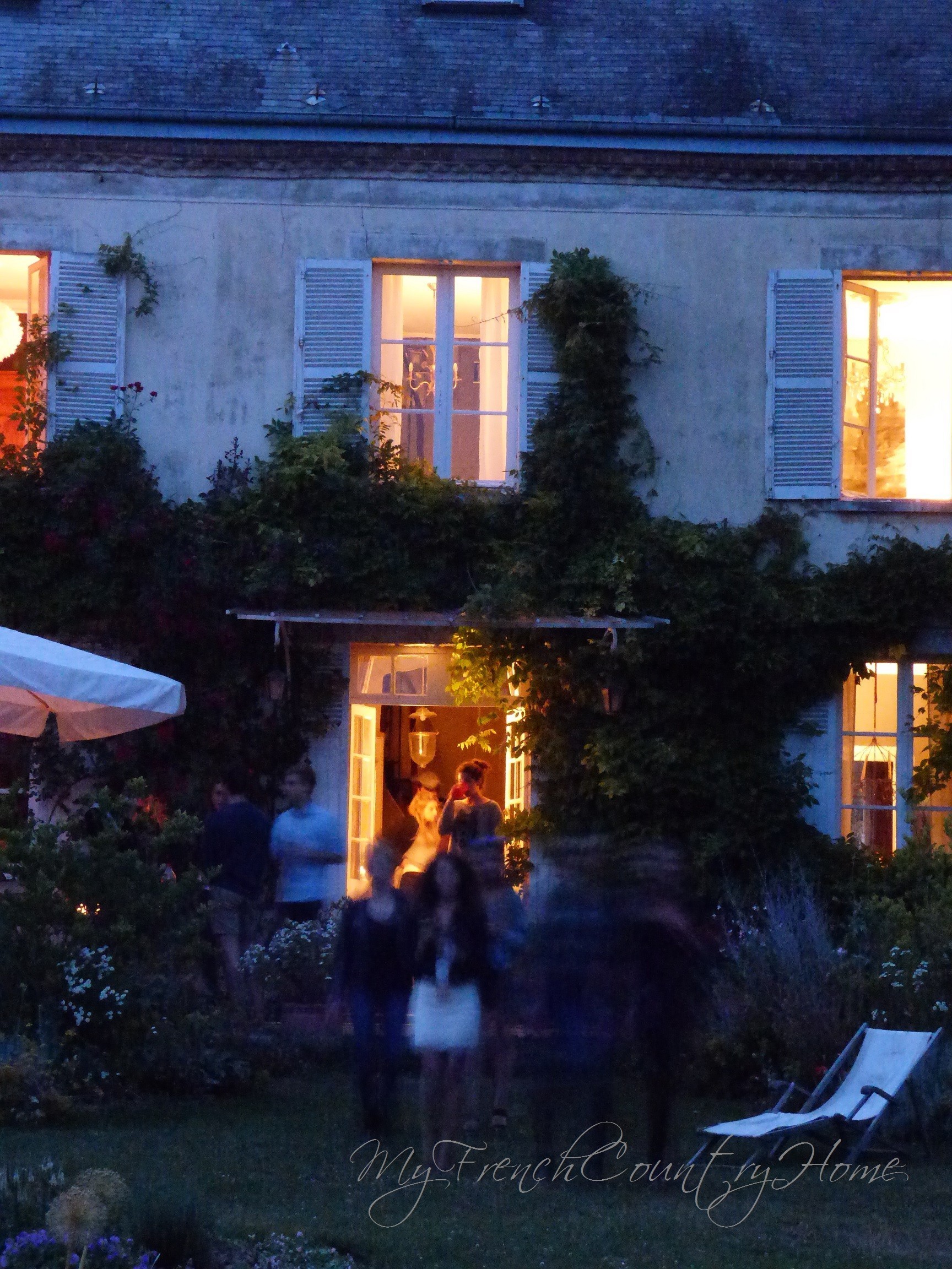 the house lit up for a party