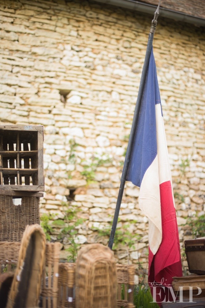 french flag outside stone barn