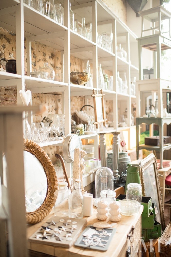 china and glass displayed on white shelves