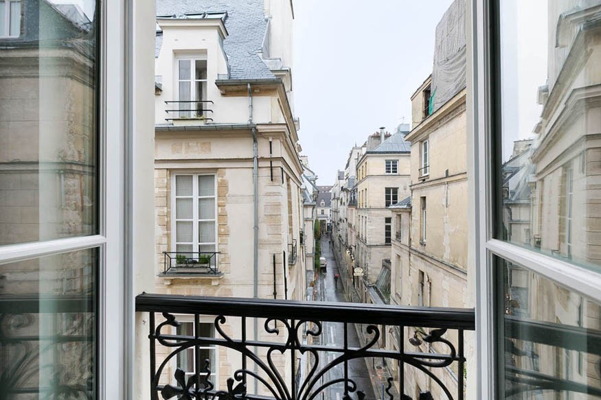 view out of a window onto a paris street