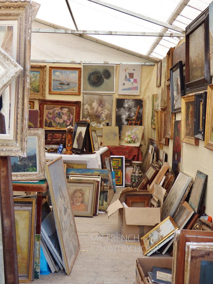 art for sale at an antique fair