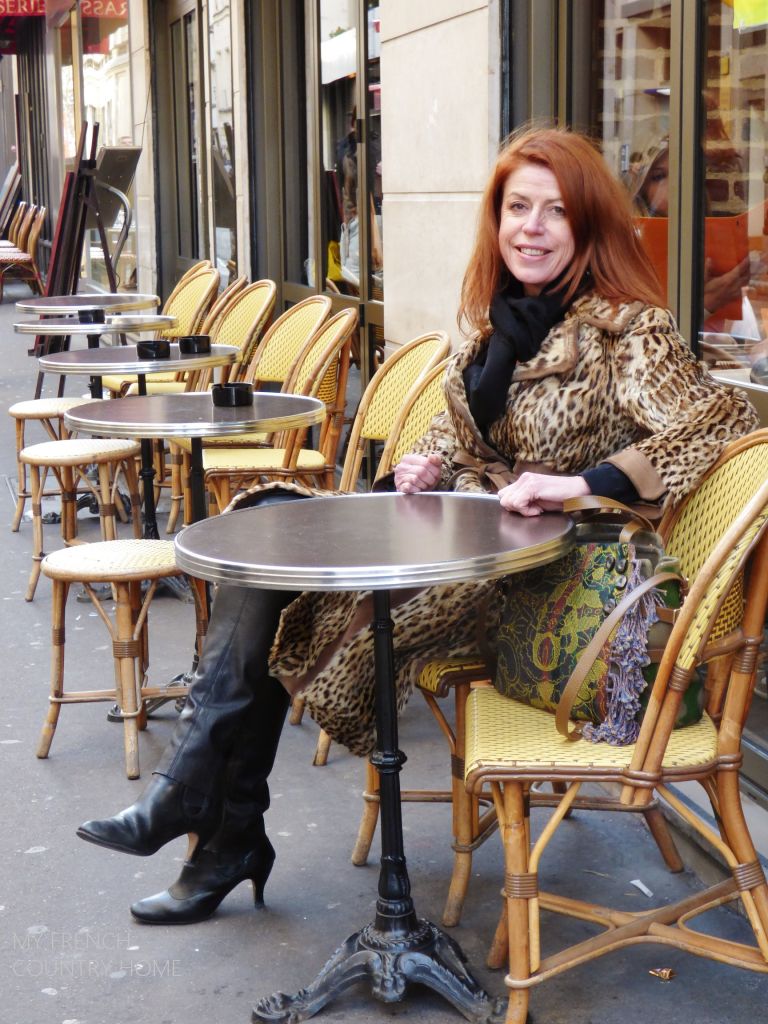 SYLIVE ROBAGLIA SEATED AT A CAFE IN PARIS