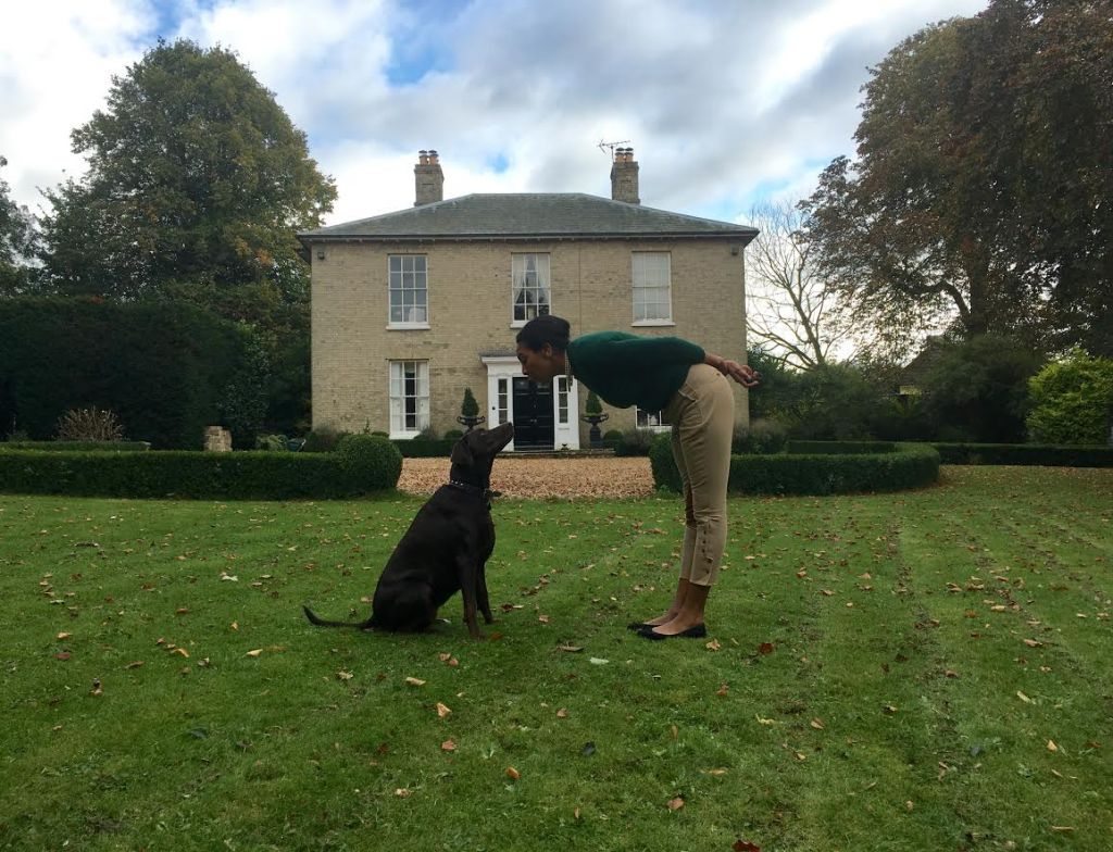 lady and dog in front of house