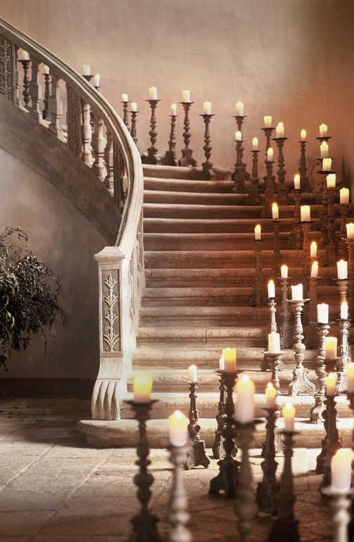 candles in stone staircase chateau de moissac