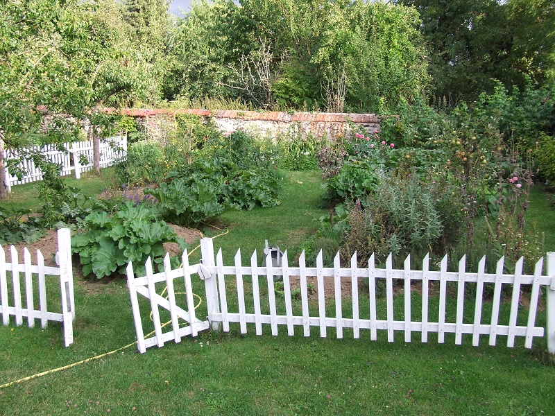 vegeatable garden with white fence