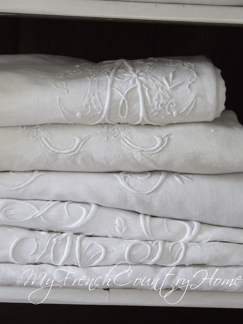 embroidered linens in cupboard