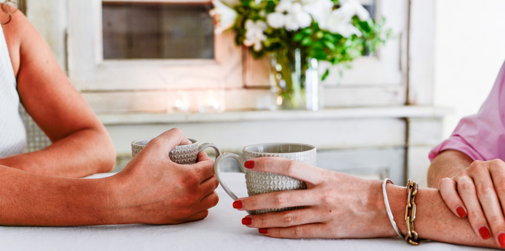 hands on coffee cups