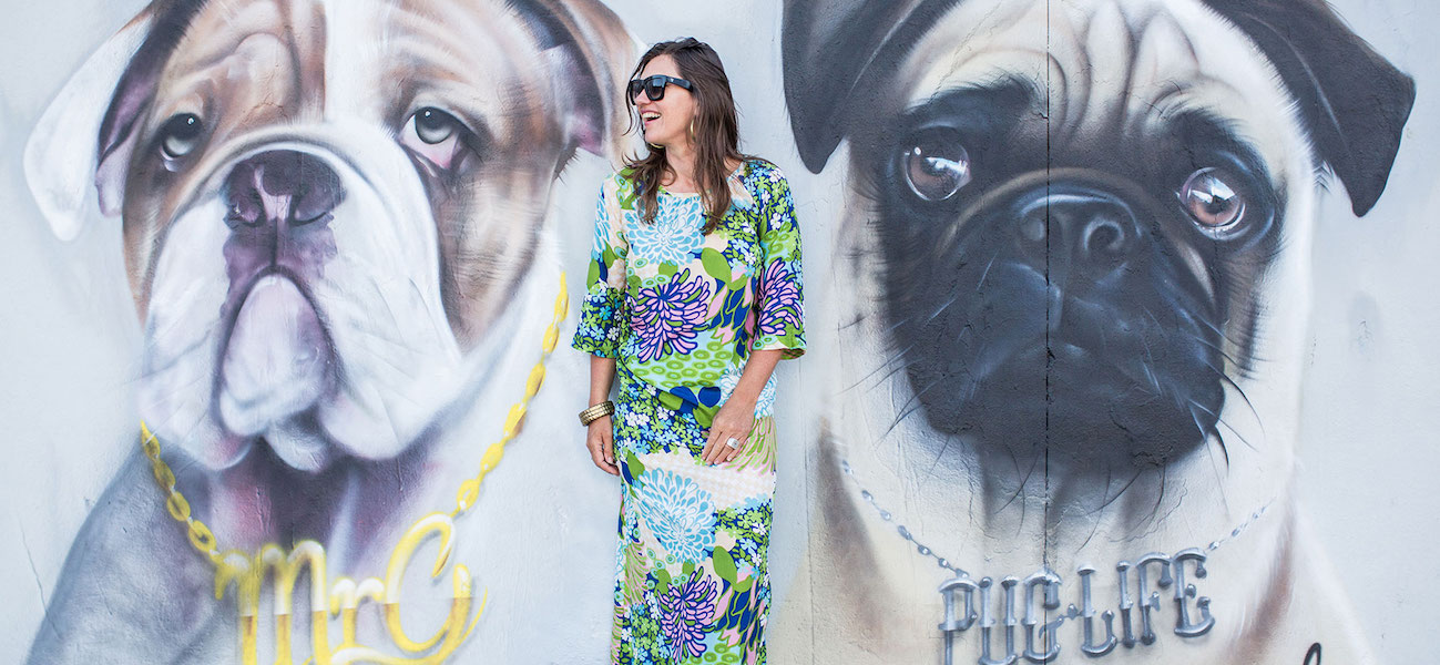 portrait of carla coulson in front of dog wall mural