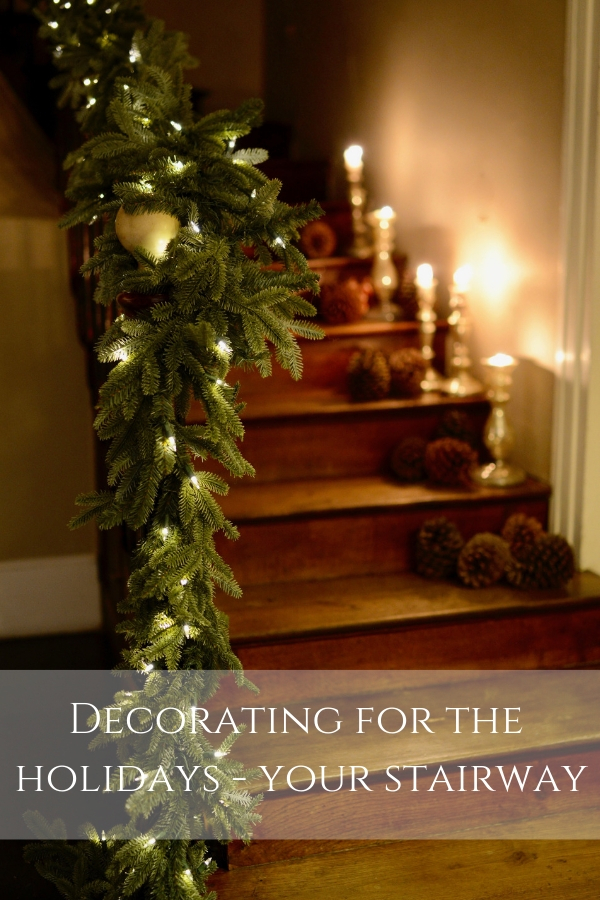 faux garland and candles on wooden staircase - decorating for the holidays