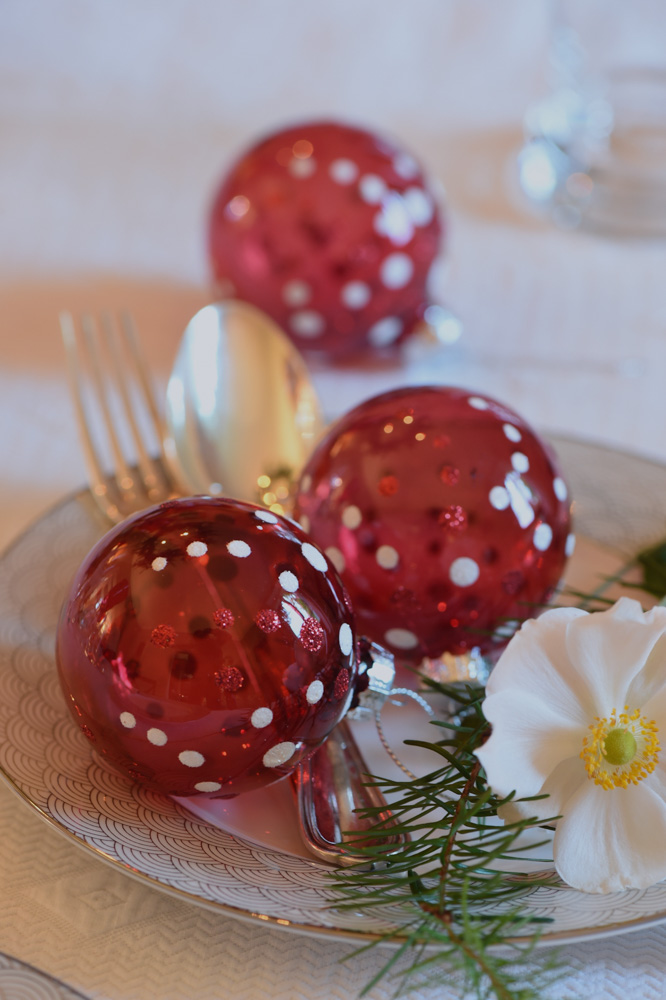 Red glass balls on a white table setting- red christmas decoration ideas- MY FRENCH COUNTRY HOME