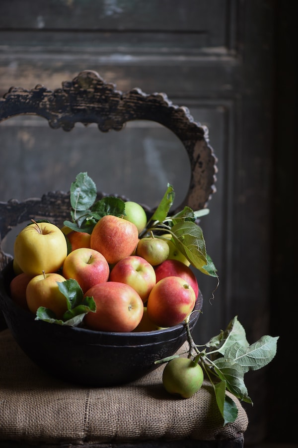 apples in a bowl on chair