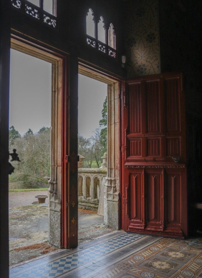 open big red doors in french chateau