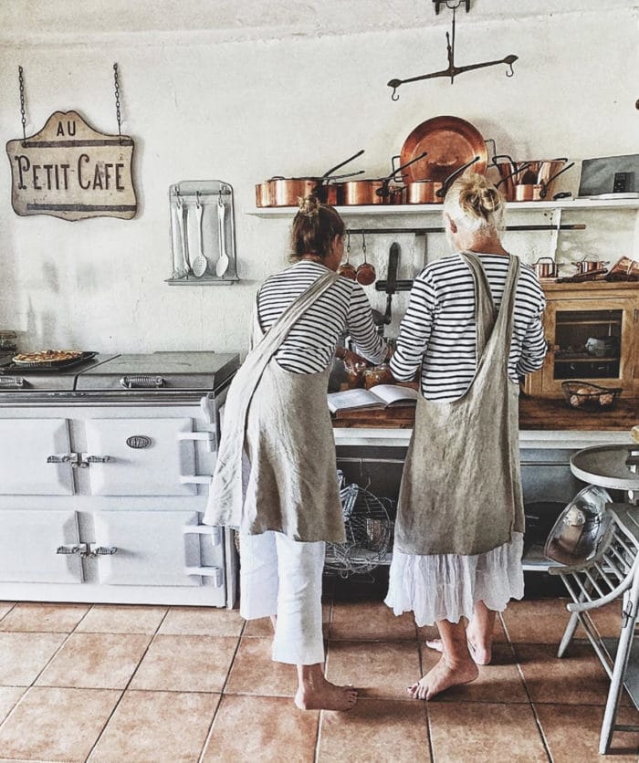 two women cook in the kitchen