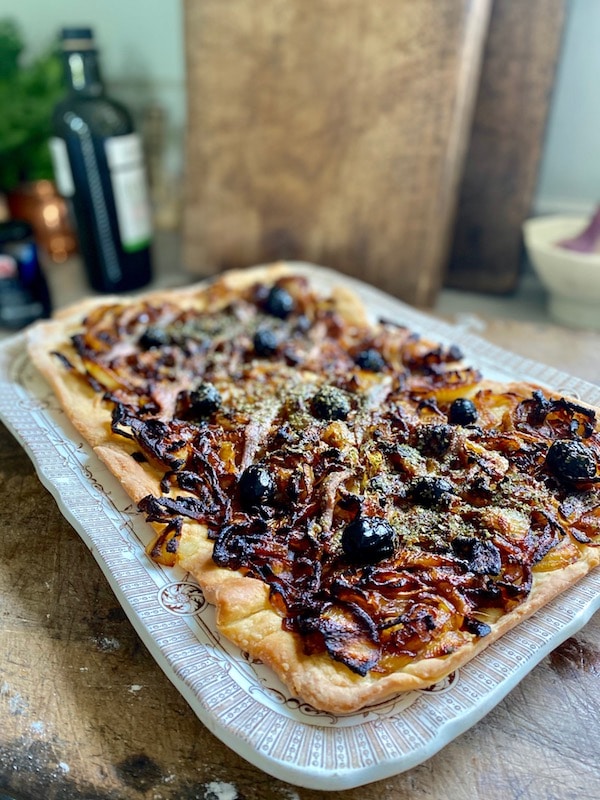 french onion tart on antique plate