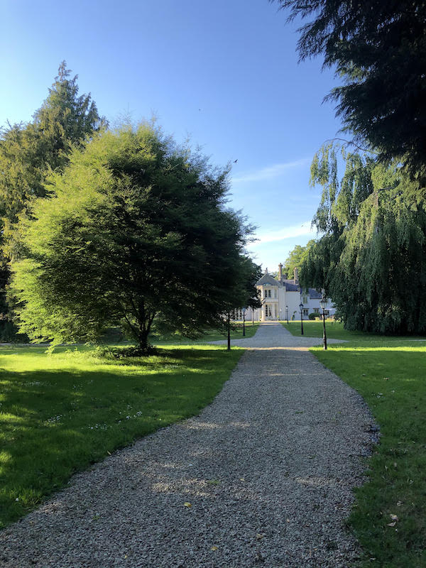 gravel path leading to french manor home
