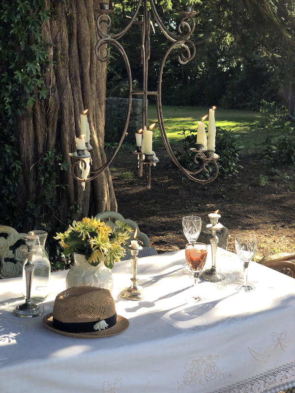 table with hate, sunflowers, chandelier