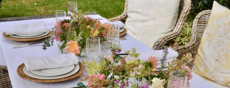 outdoor tablescape with crystal and flowers