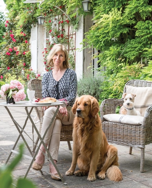 portrait of woman outside with two dogs