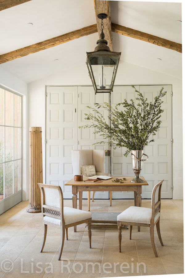 living room with table, two chairs and plant