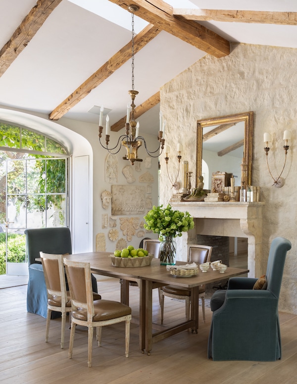 kitchen table of farmhouse with blue armchairs and wooden chairs