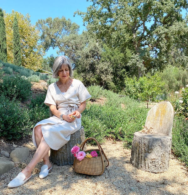 women sitting outside with basket of flowers