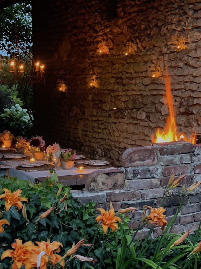 table laid for outdoor dining by barbecue